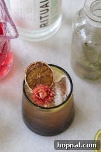 Thanksgiving mocktail in a glass with apple cider and cranberry.