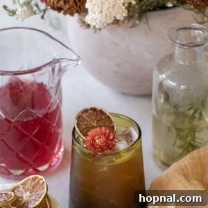 Thanksgiving mocktail in a green glass with cranberry juice and flowers.