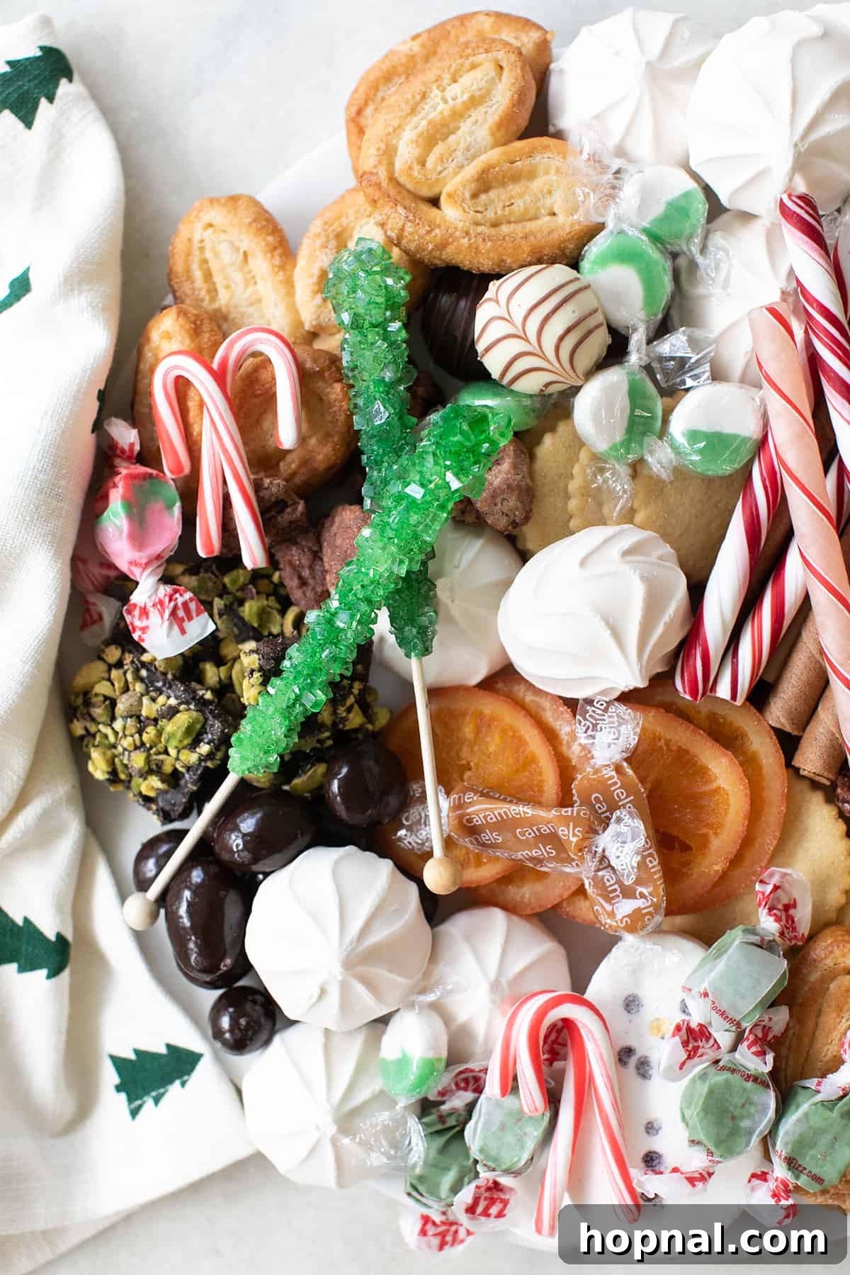 A beautifully arranged Christmas dessert charcuterie board featuring various festive sweets and treats, perfect for holiday gatherings.