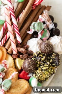 Cookies, truffles, candy canes and holiday candy on a dessert platter.