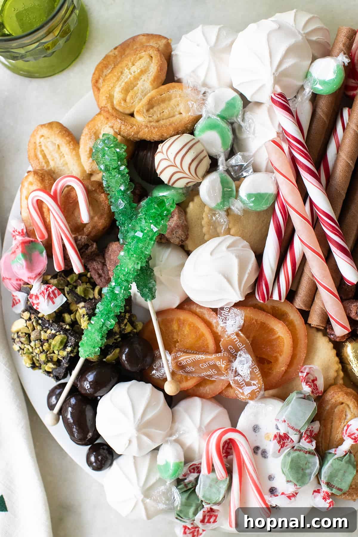 A vibrant and festive candy platter brimming with an assortment of holiday treats, arranged to perfection for a Christmas party.