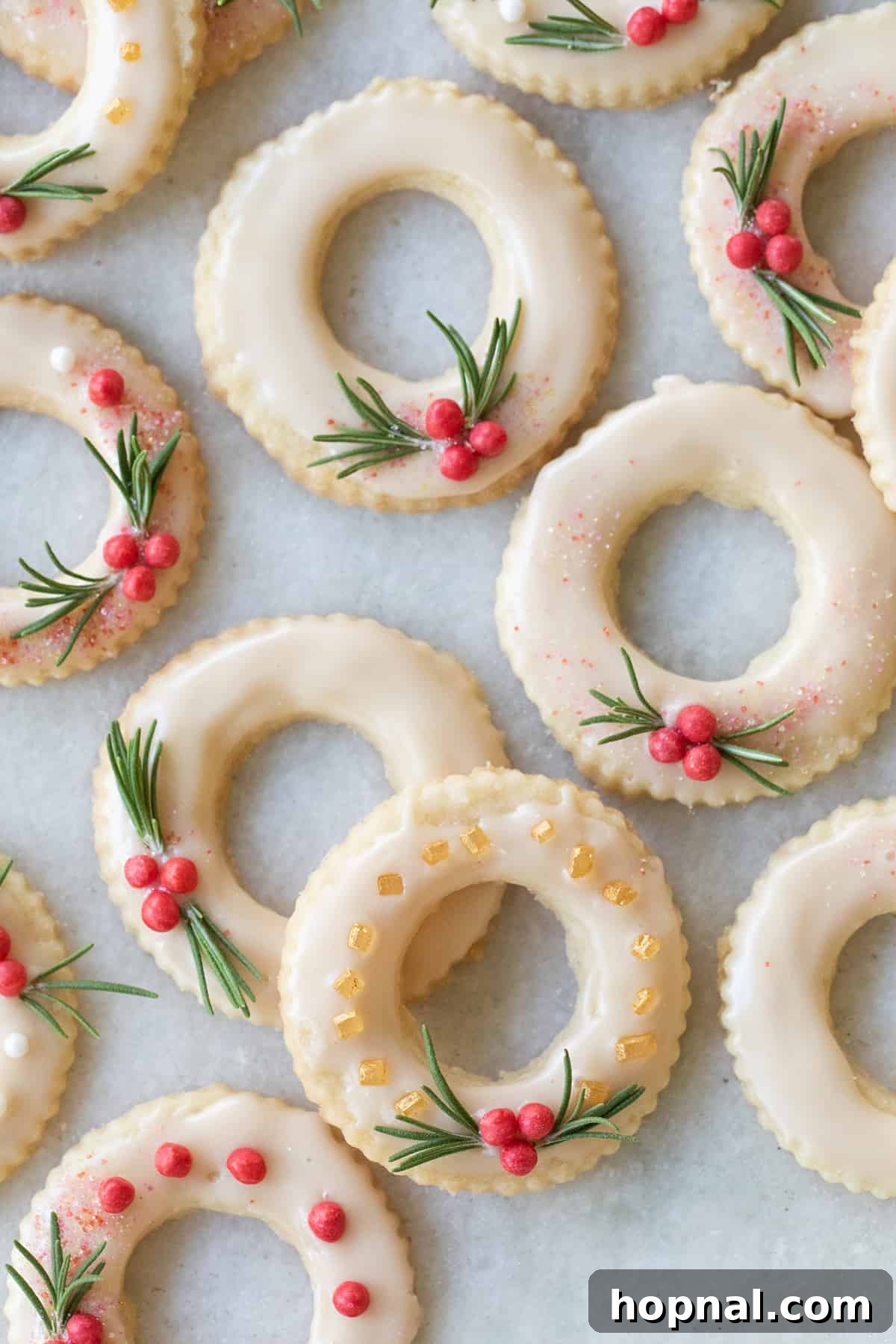 Festive Christmas wreath cookies decorated with vibrant sprinkles and a red candy accent, ready for holiday celebrations.