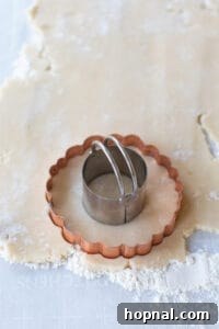A wreath cookie cutter shown on rolled-out dough.