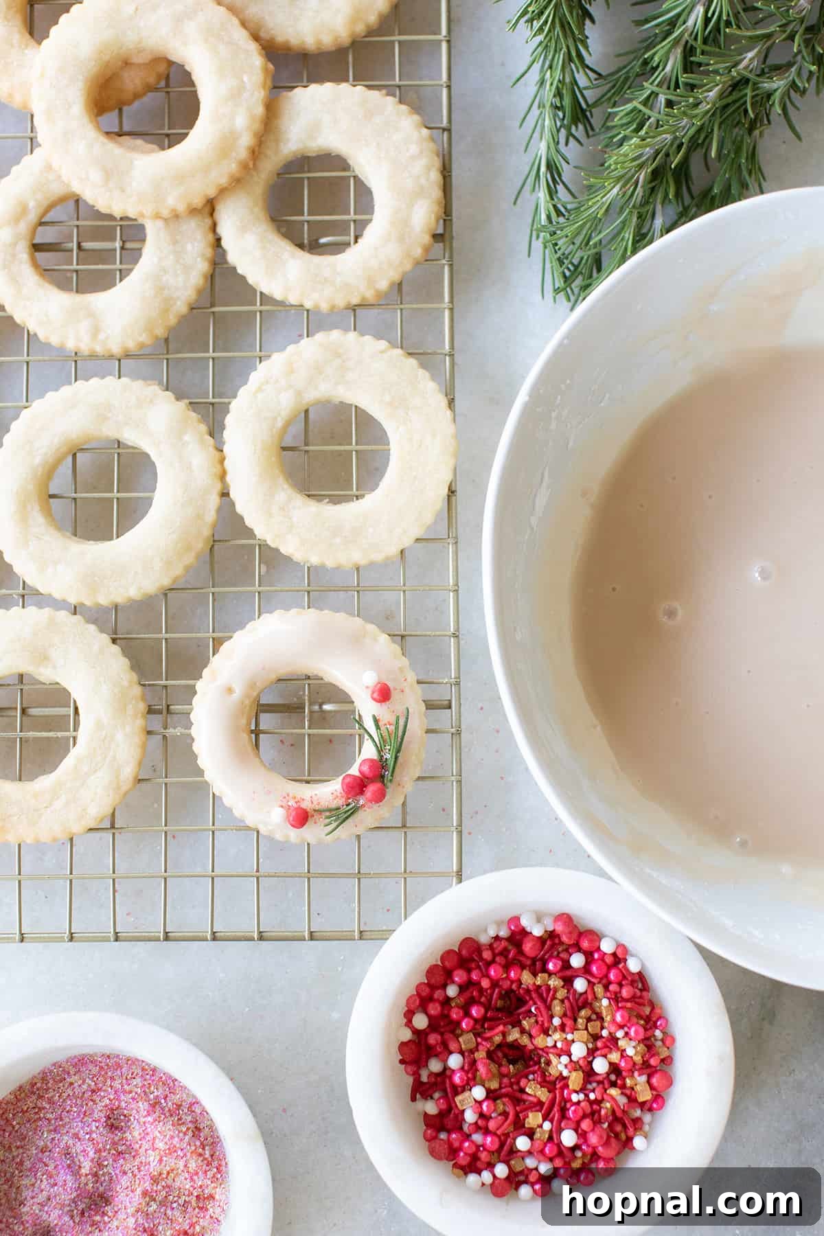 A close-up of beautifully glazed wreath cookies, adorned with colorful sprinkles, showcasing their festive appeal.