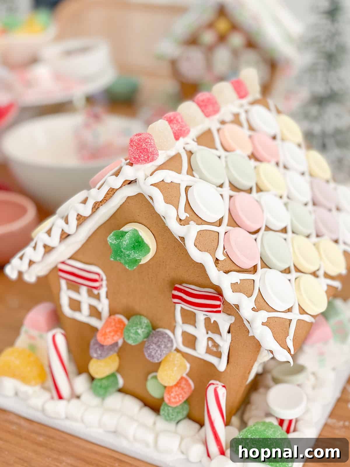 A beautifully decorated gingerbread house adorned with various candies and icing, showcasing holiday spirit.