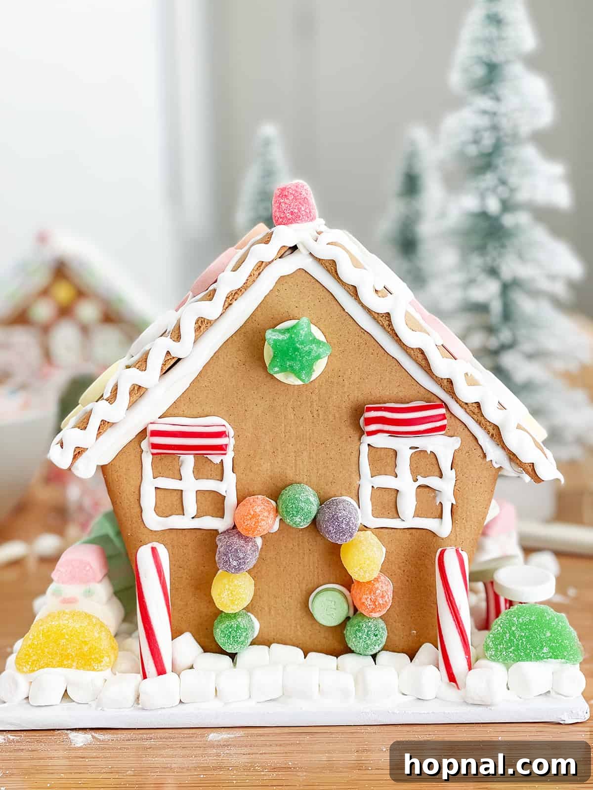 A charming, meticulously decorated gingerbread house, a symbol of festive holiday crafting.