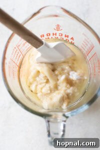 Golden Banana Blueberry Treats 11 Mashed bananas and sour cream in a measuring cup, mixed with other wet ingredients.