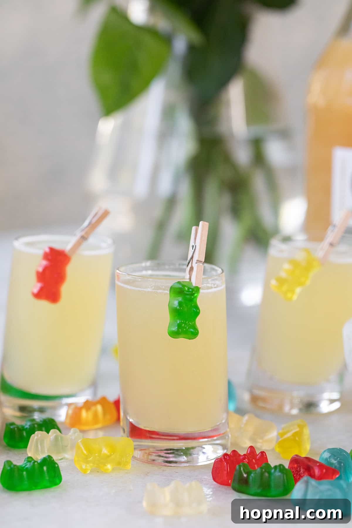 Tipsy Teddy Shot 3 Multiple Gummy Bear Shots lined up, each with a colorful gummy bear garnish, showcasing a vibrant display perfect for a party.