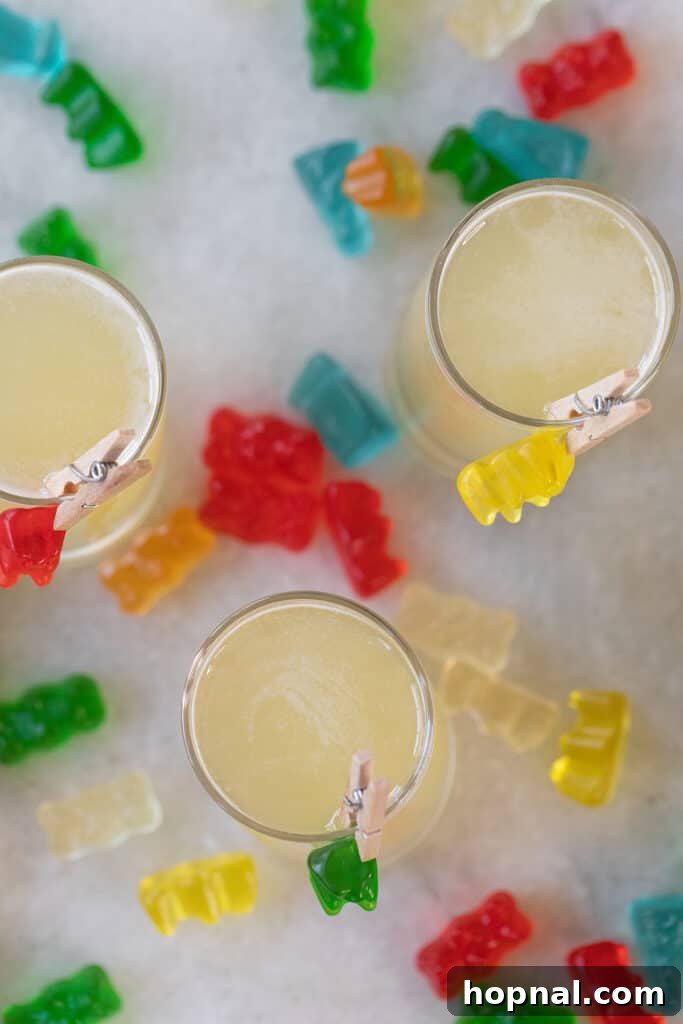Tipsy Teddy Shot 7 Several colorful Gummy Bear Shots arranged neatly, each garnished with a gummy bear, ready for serving.