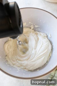 Beating ricotta with an electric mixer until light and fluffy.