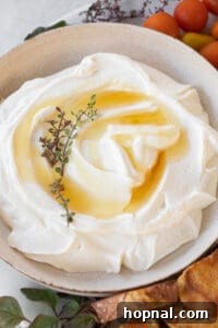 Honey drizzled over whipped ricotta, ready for serving.