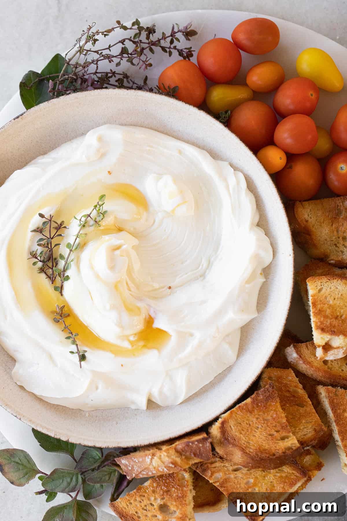 A scoop being taken out of a whipped ricotta dip, showing its creamy texture.