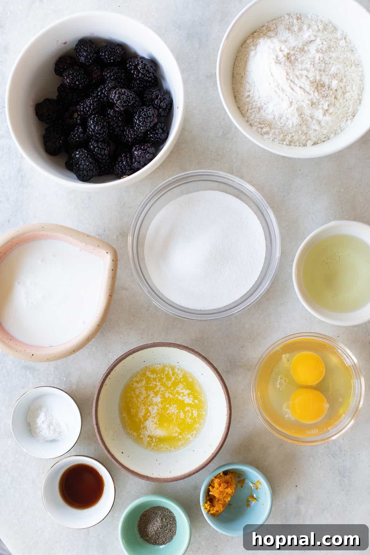 Blackberries, eggs, sugar, buttermilk, orange zest, flour, oil and spices in small bowls.