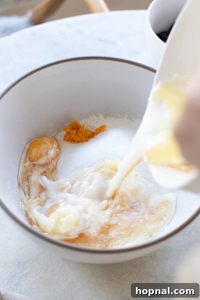 Adding wet ingredients into dry ingredients.