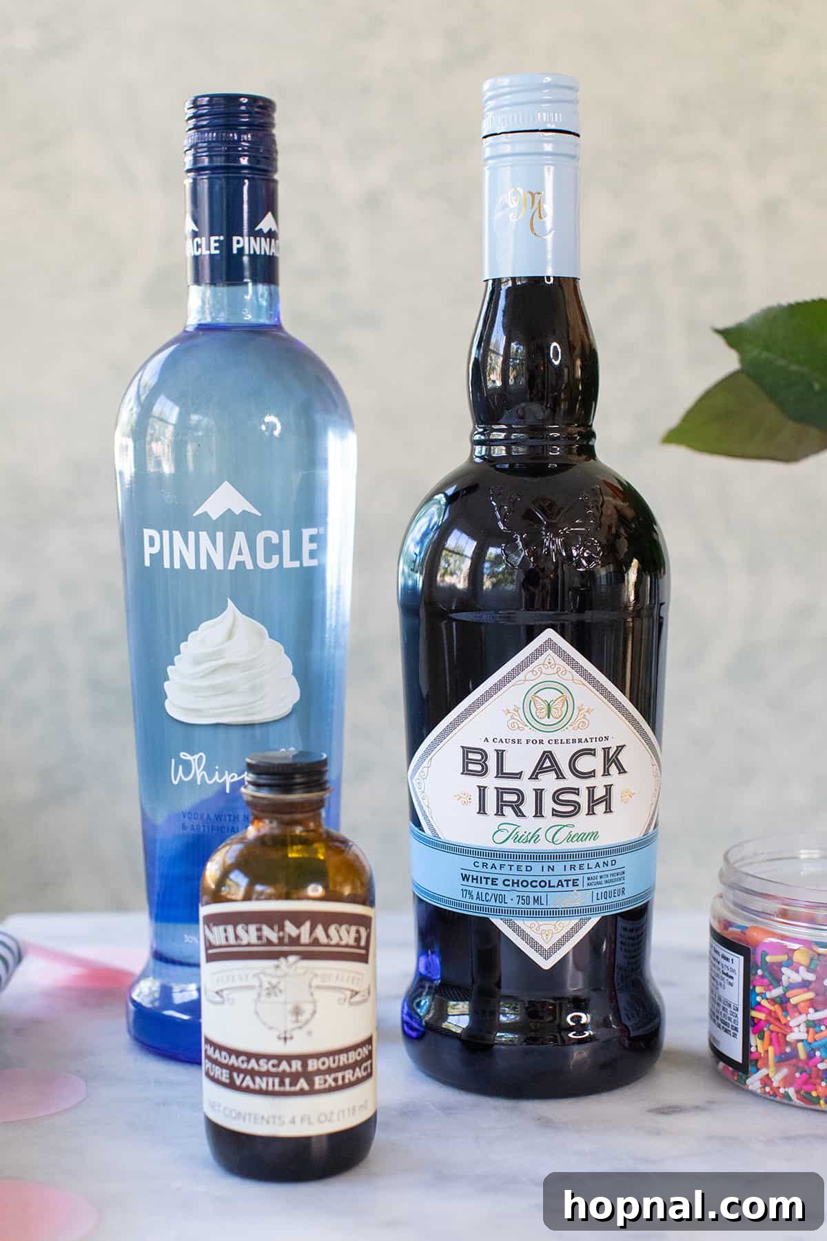 A bottle of white chocolate Irish Cream liqueur, a key ingredient for a creamy birthday cake shot.