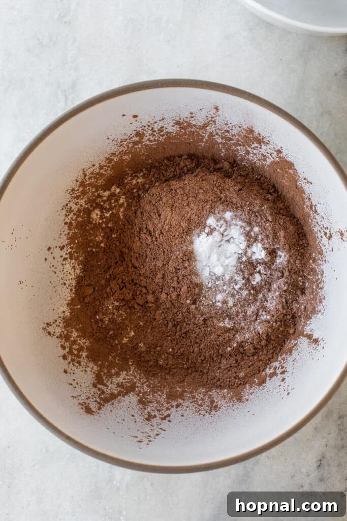 Dry chocolate cake ingredients in a mixing bowl, ready to be combined.