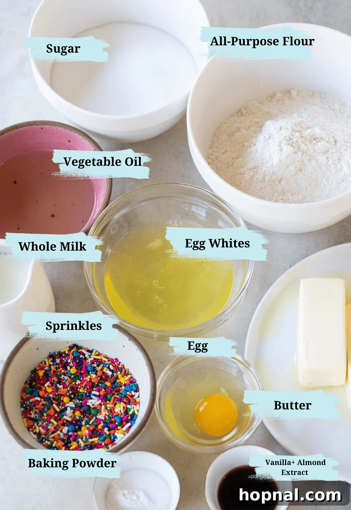 Confetti cupcake ingredients in bowls with titles to show what they are. 
