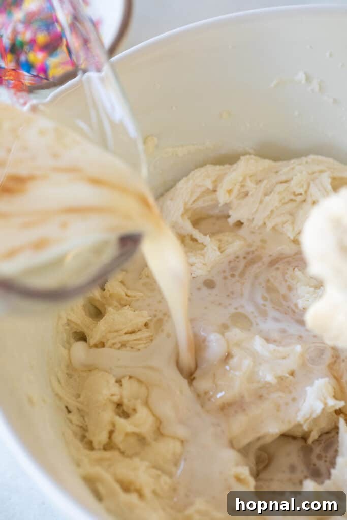 Alternating dry ingredients and wet ingredients.