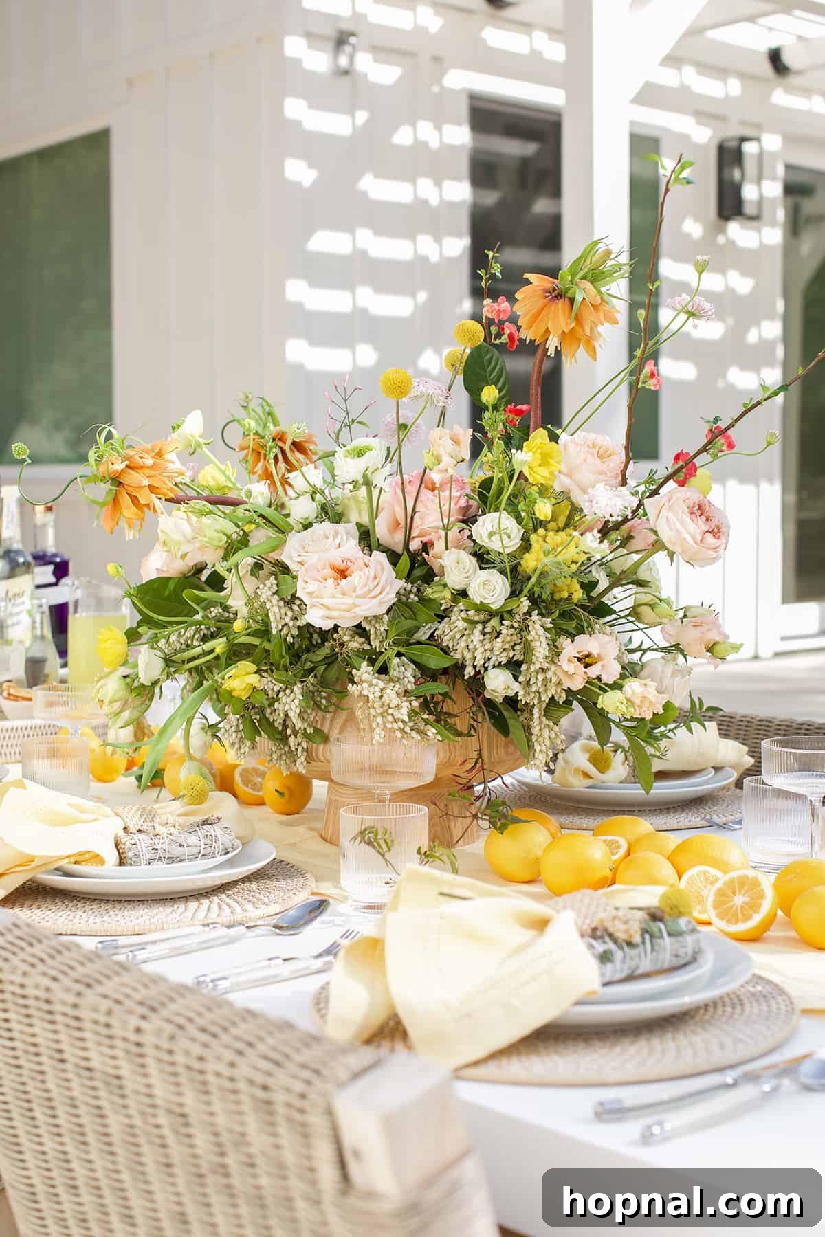 Spring Gatherings: A Lemon-Kissed Table 2 Vibrant spring table setting adorned with yellow flowers, fresh lemons, and elegant dinnerware, ready for a spring gathering.
