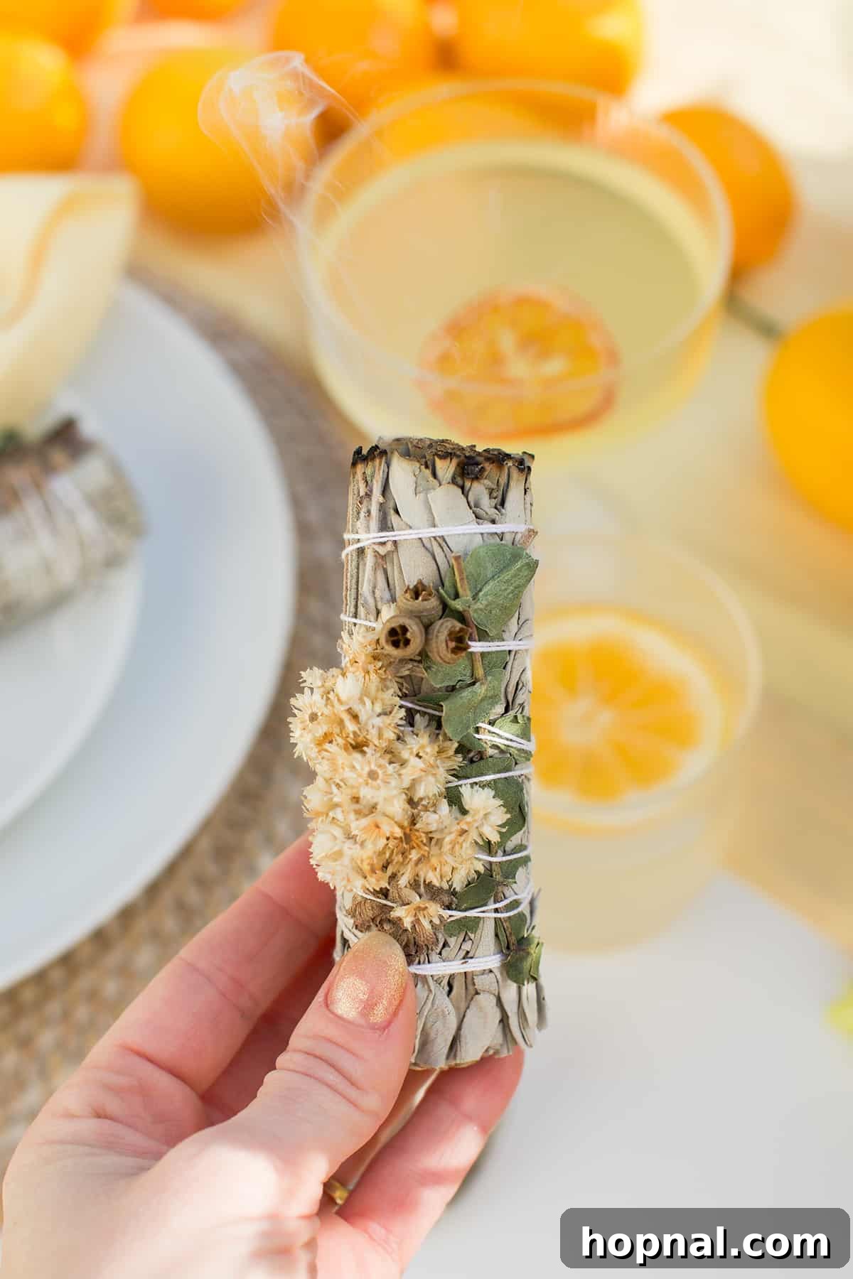 Spring Gatherings: A Lemon-Kissed Table 13 A sage bundle burning gently, adding an aromatic and cleansing touch to the spring gathering ambiance.