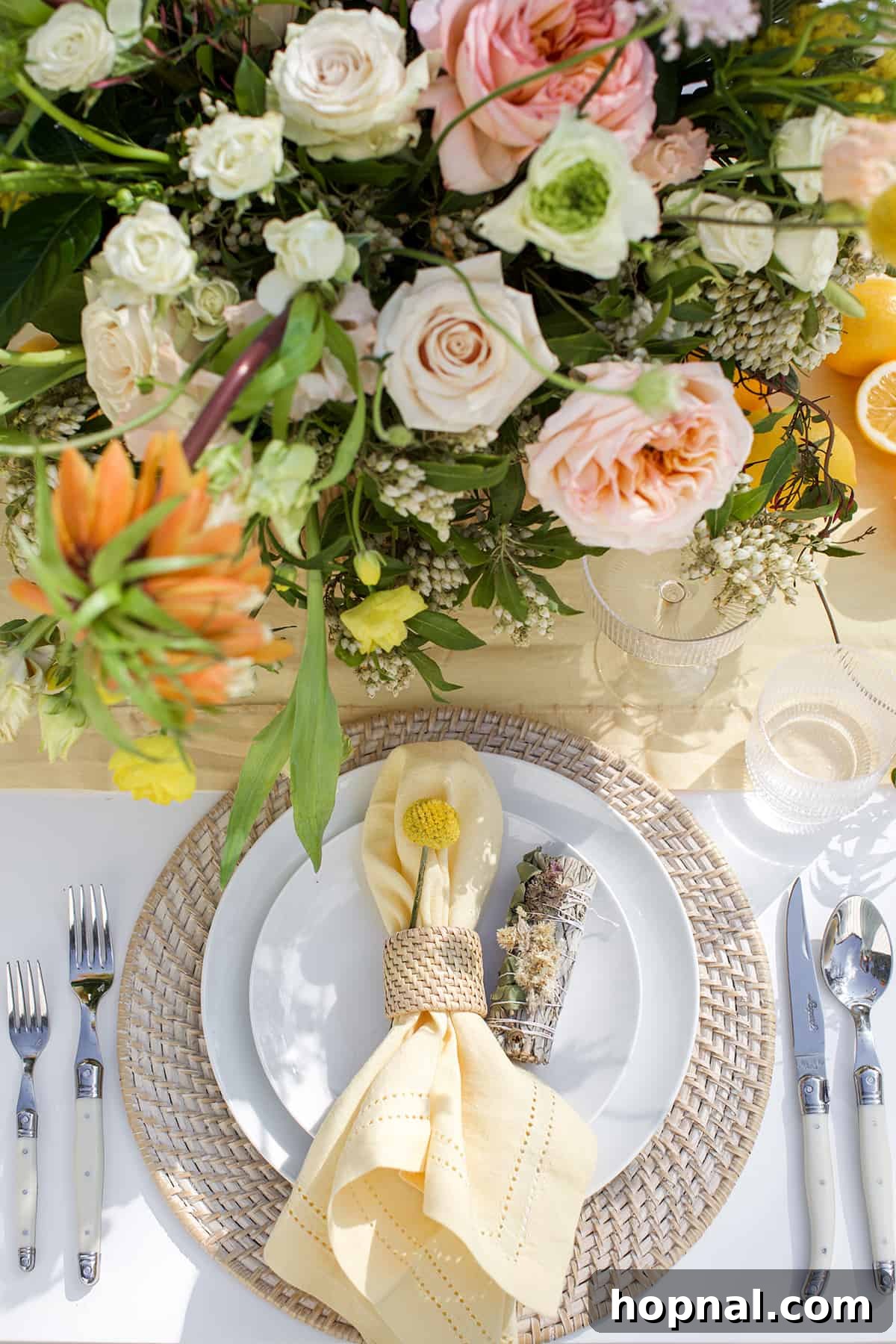 Spring Gatherings: A Lemon-Kissed Table 16 A serene spring table setting adorned with vibrant flowers, fresh lemons, and fragrant sage bundles.