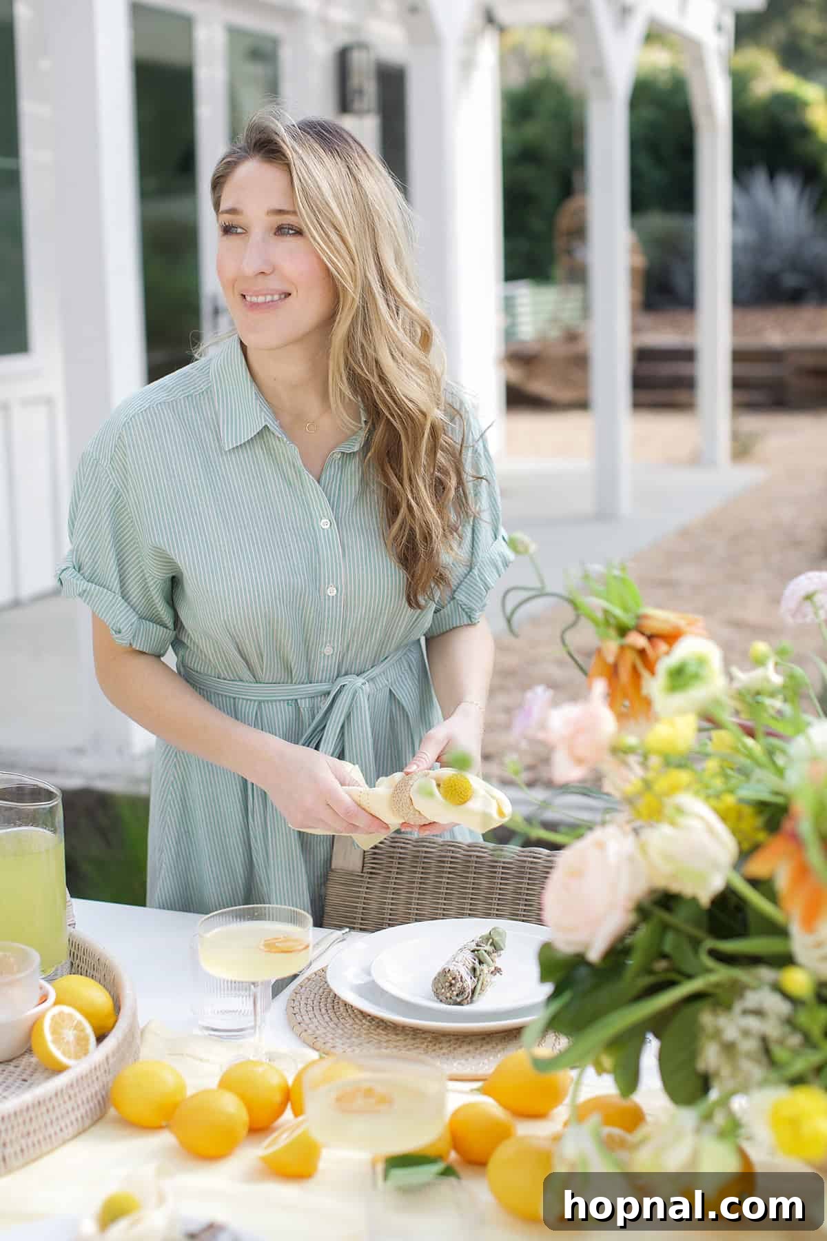Spring Gatherings: A Lemon-Kissed Table 3 Eden Passante arranging flowers and elements for a spring party, showcasing elegant hosting.