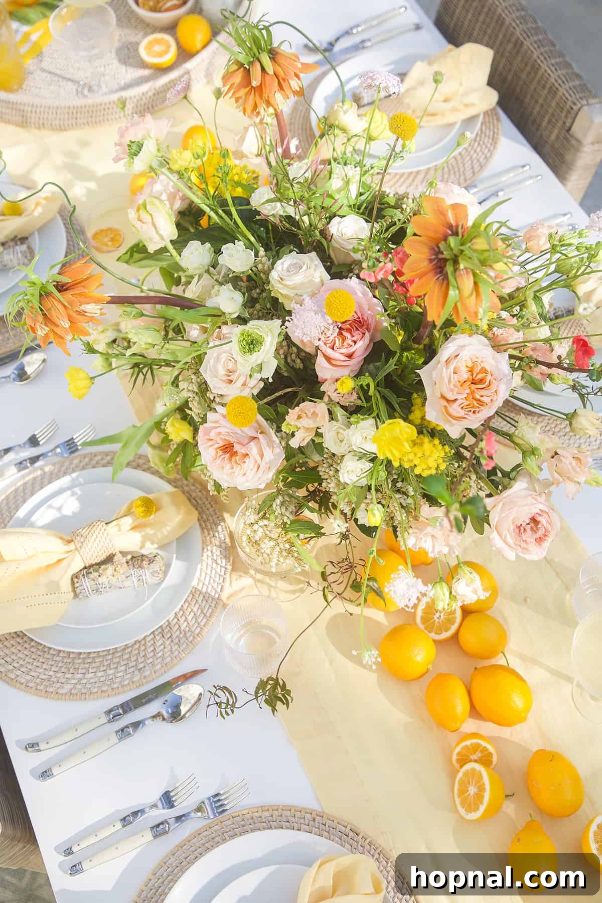 Spring Gatherings: A Lemon-Kissed Table 5 A beautifully decorated lemon themed table with a vibrant display of lemons and spring flowers as a centerpiece.