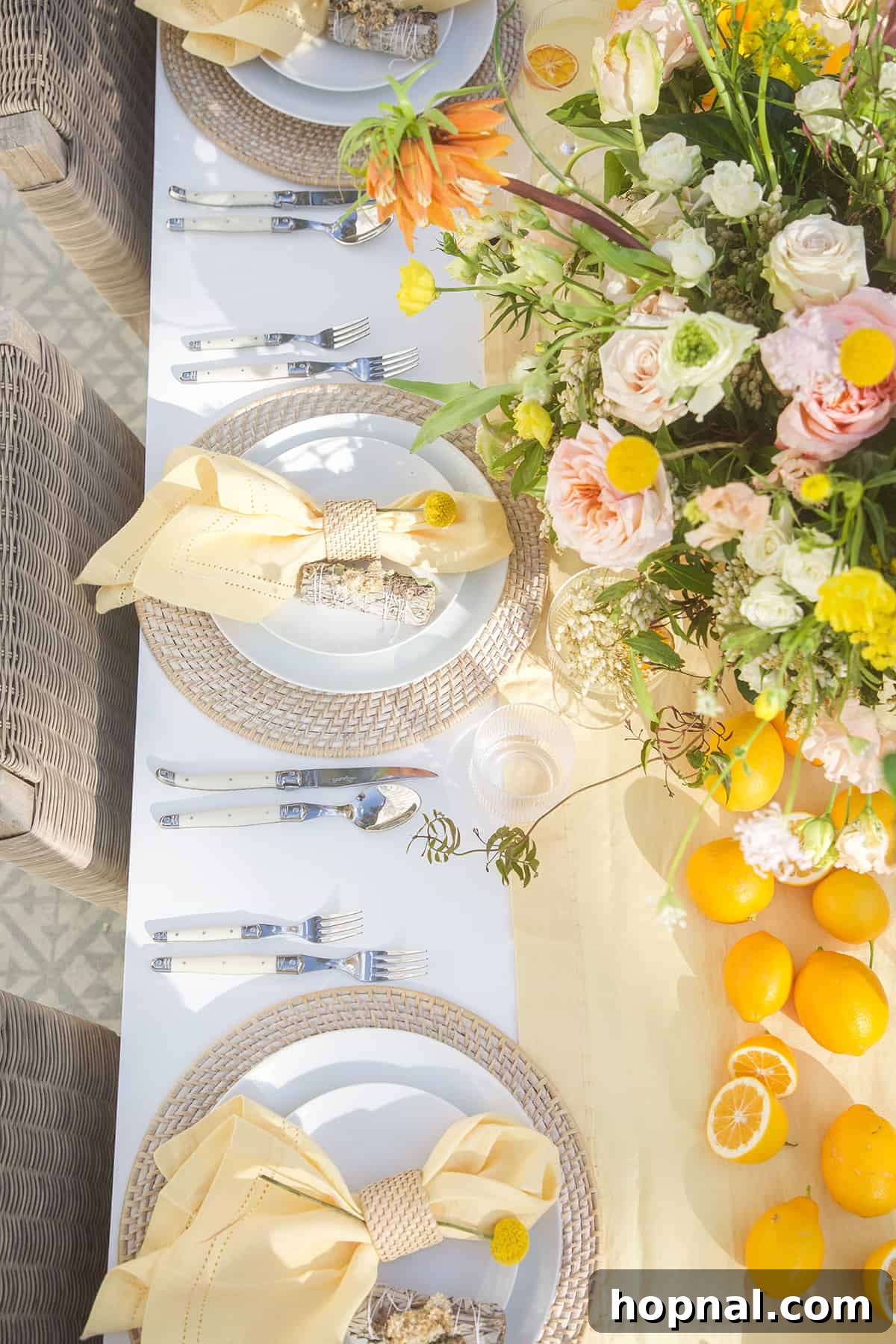 Spring Gatherings: A Lemon-Kissed Table 7 A meticulously arranged spring table setting featuring white plates, wicker chargers, yellow napkins, and a floral centerpiece.