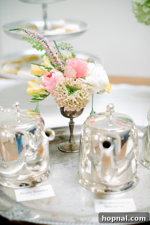 Mom's Garden Tea Oasis 16 Elegant silver tea kettle filled with hot tea, ready to be served