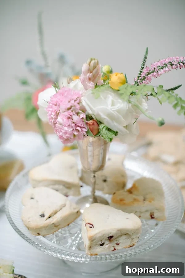 Mom's Garden Tea Oasis 6 Elegant three-tiered stand showcasing an assortment of heart-shaped scones for the tea party