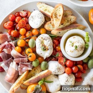 Burrata Platter with marinated tomatoes, crackers, olives and crostini.