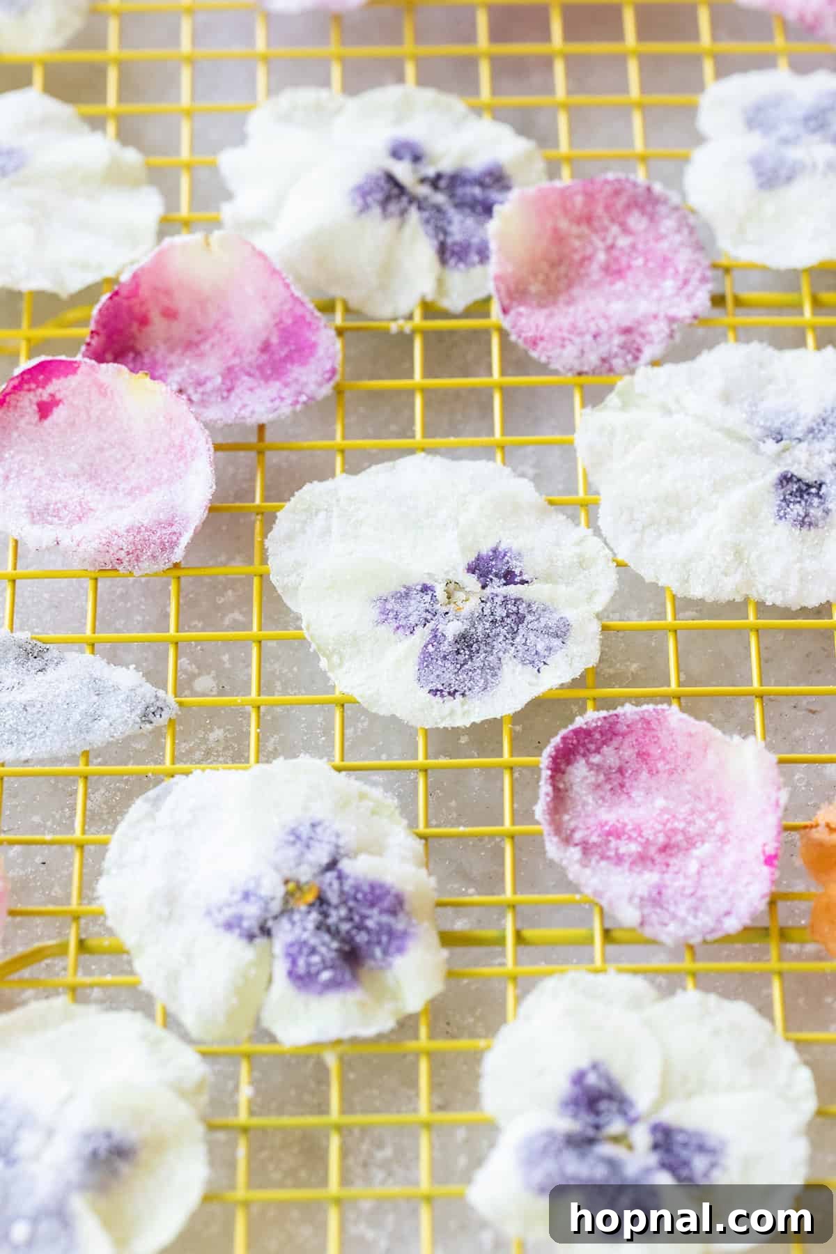 Edible sugar flowers drying on a cooling rack.