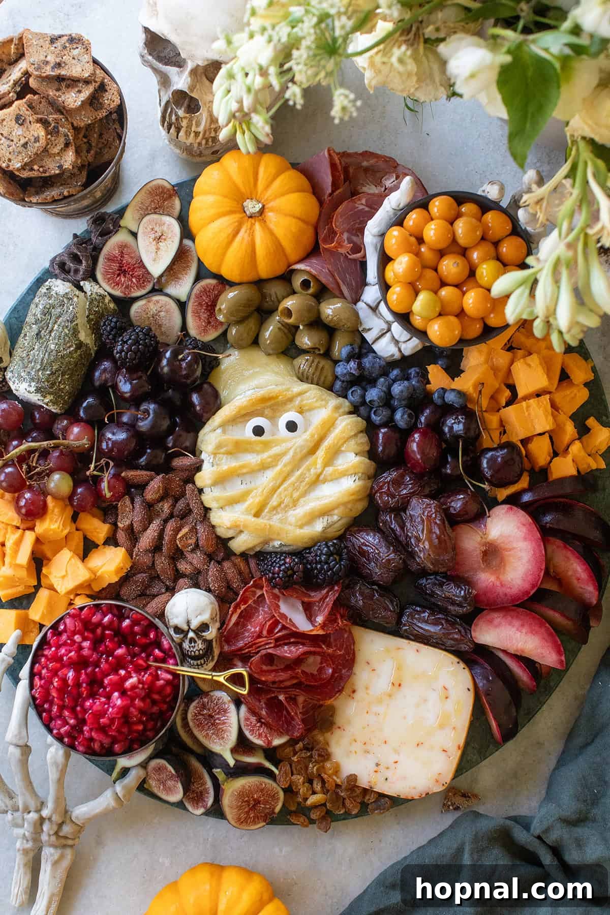 Halloween cheese platter with mummy brie as the centerpiece.