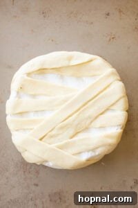 Brie wheel wrapped in puff pastry slices.