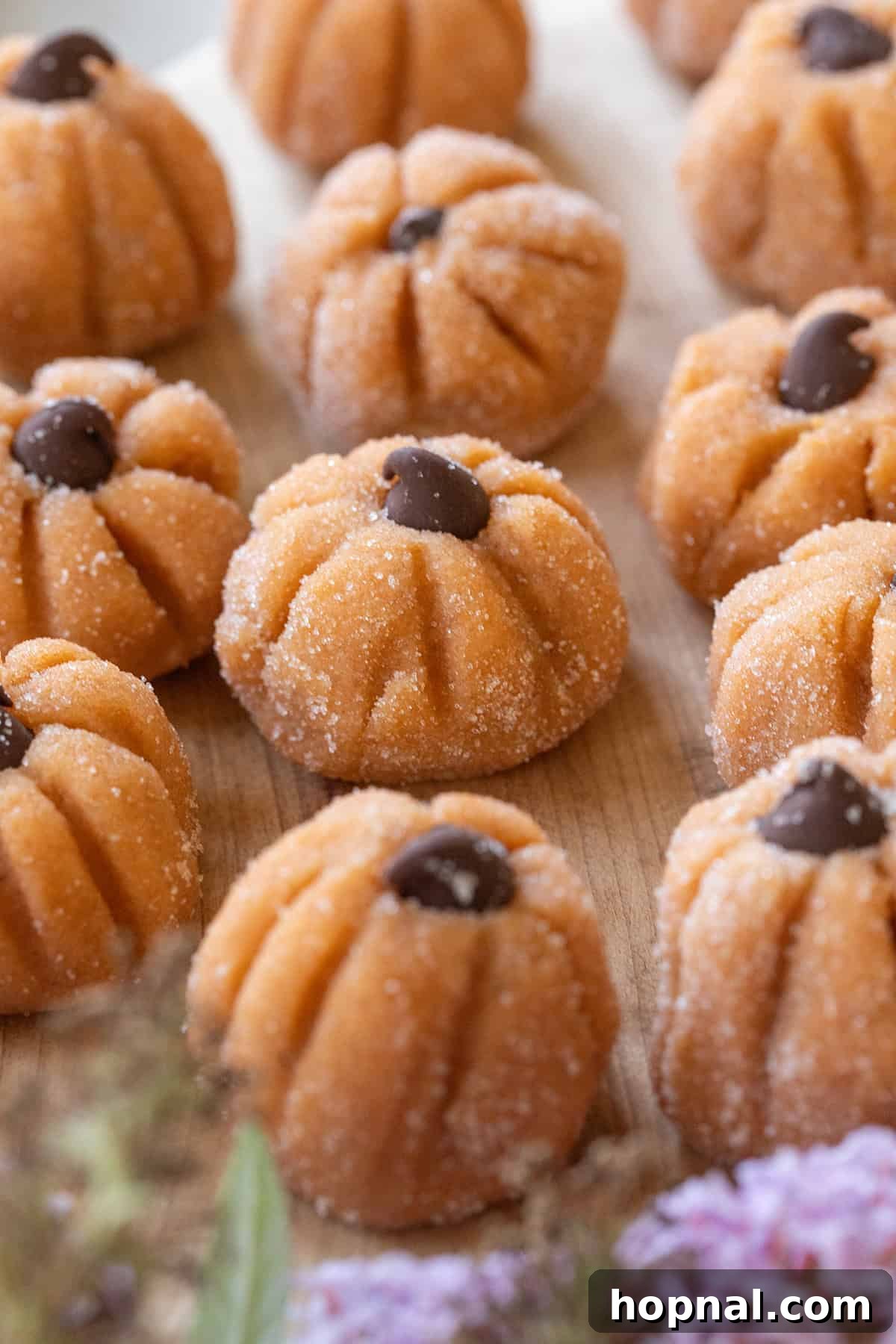 The cutest mini pumpkin cheesecake truffles with chocolate chips. Garnish with tiny stems for a festive look.