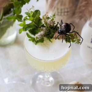 Sake sour recipe made into a Halloween cocktail with spooky garnishes.