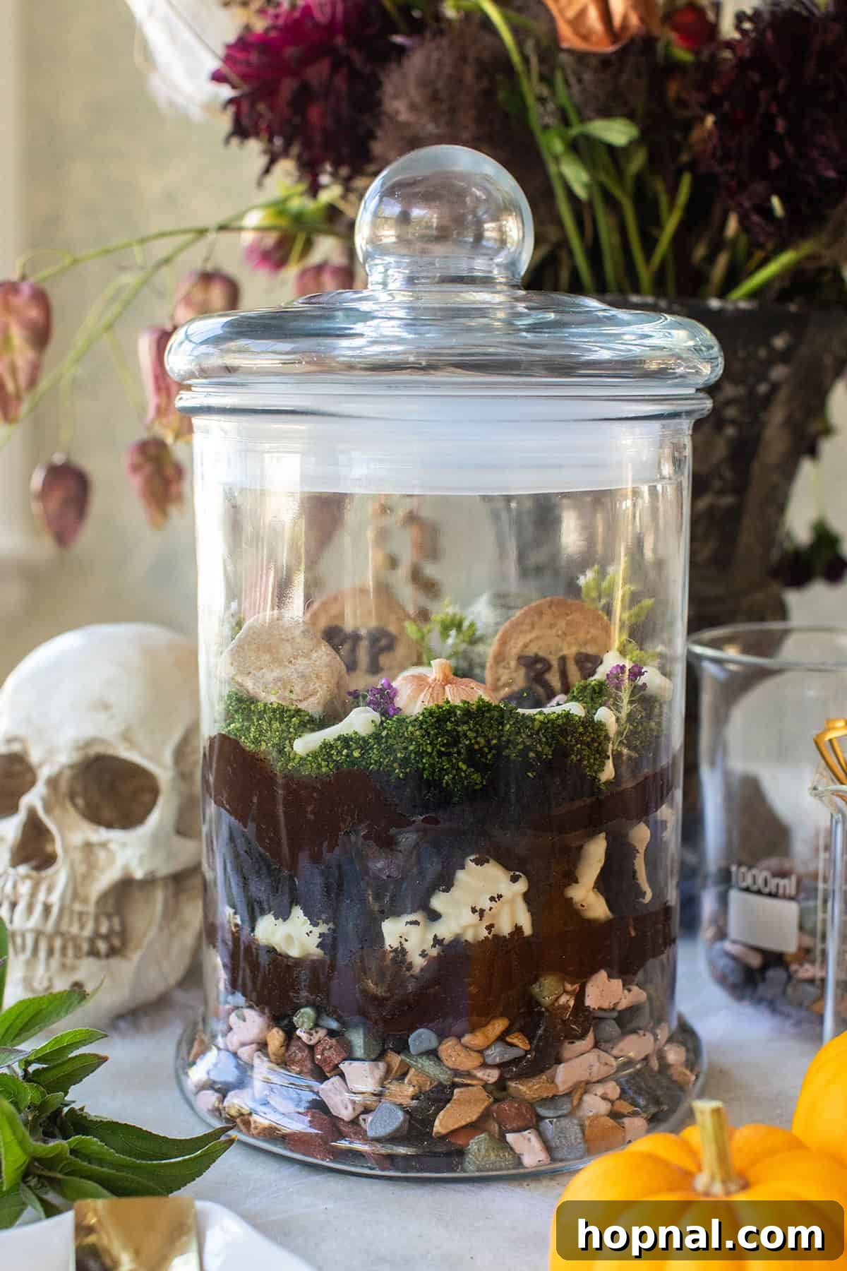 A large Halloween centerpiece that is edible and decorated as a spooky terrarium.