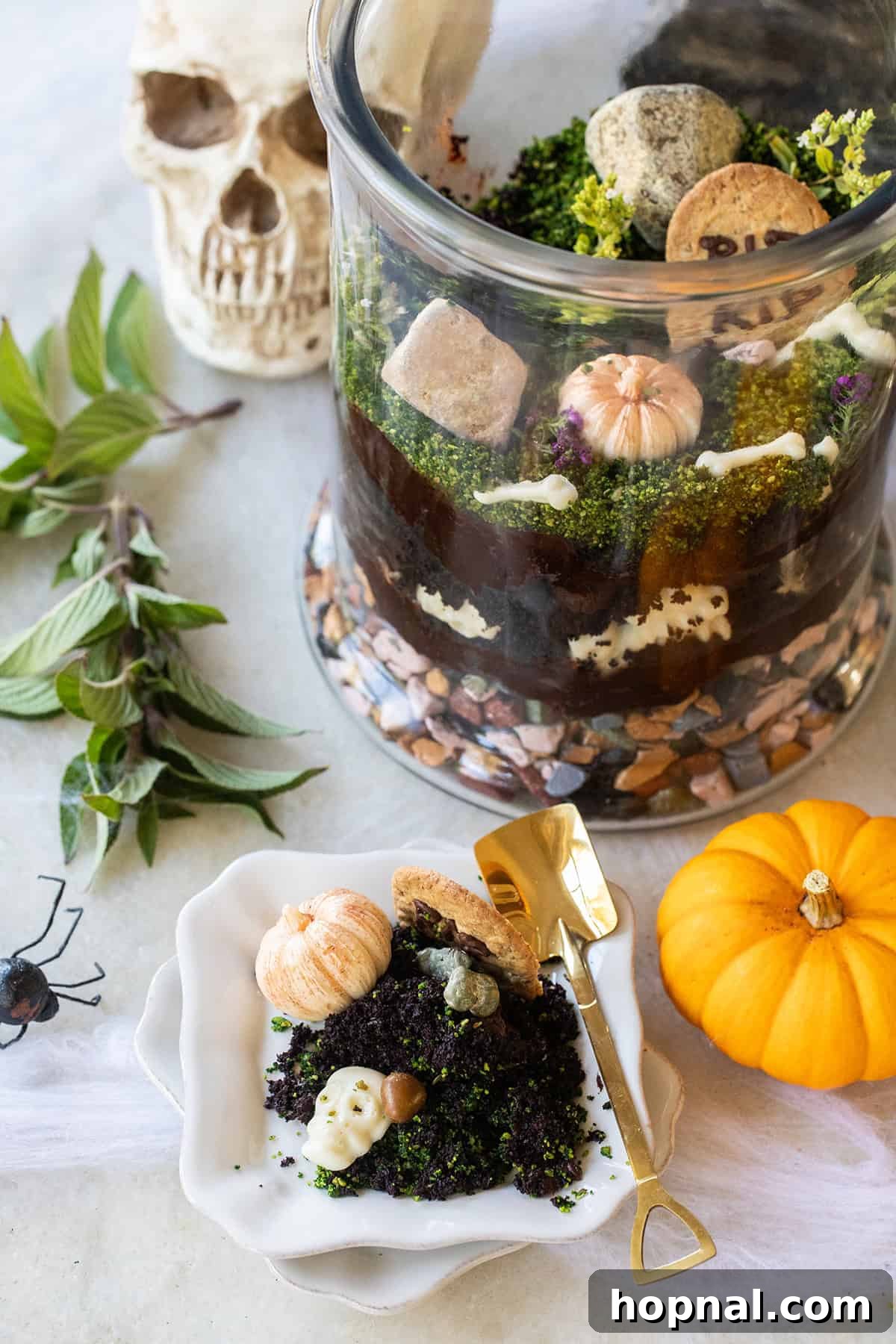 Edible Halloween terrarium centerpiece for a party, showcasing layers and decorations.
