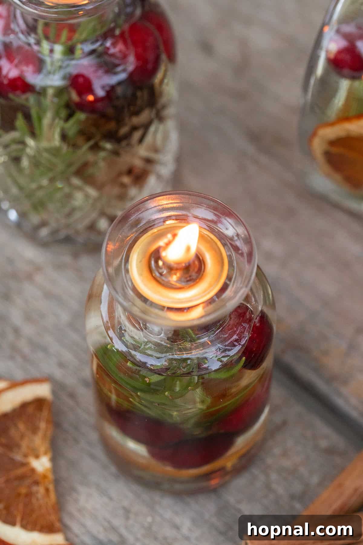 A lit homemade oil candle, elegantly placed on a table, showcasing its warm and inviting glow for a party setting.