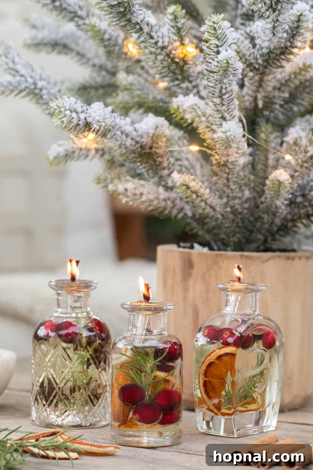 Elegantly arranged olive oil candles, perfect for a Christmas party, adorned with vibrant berries and fresh rosemary, creating a festive ambiance.