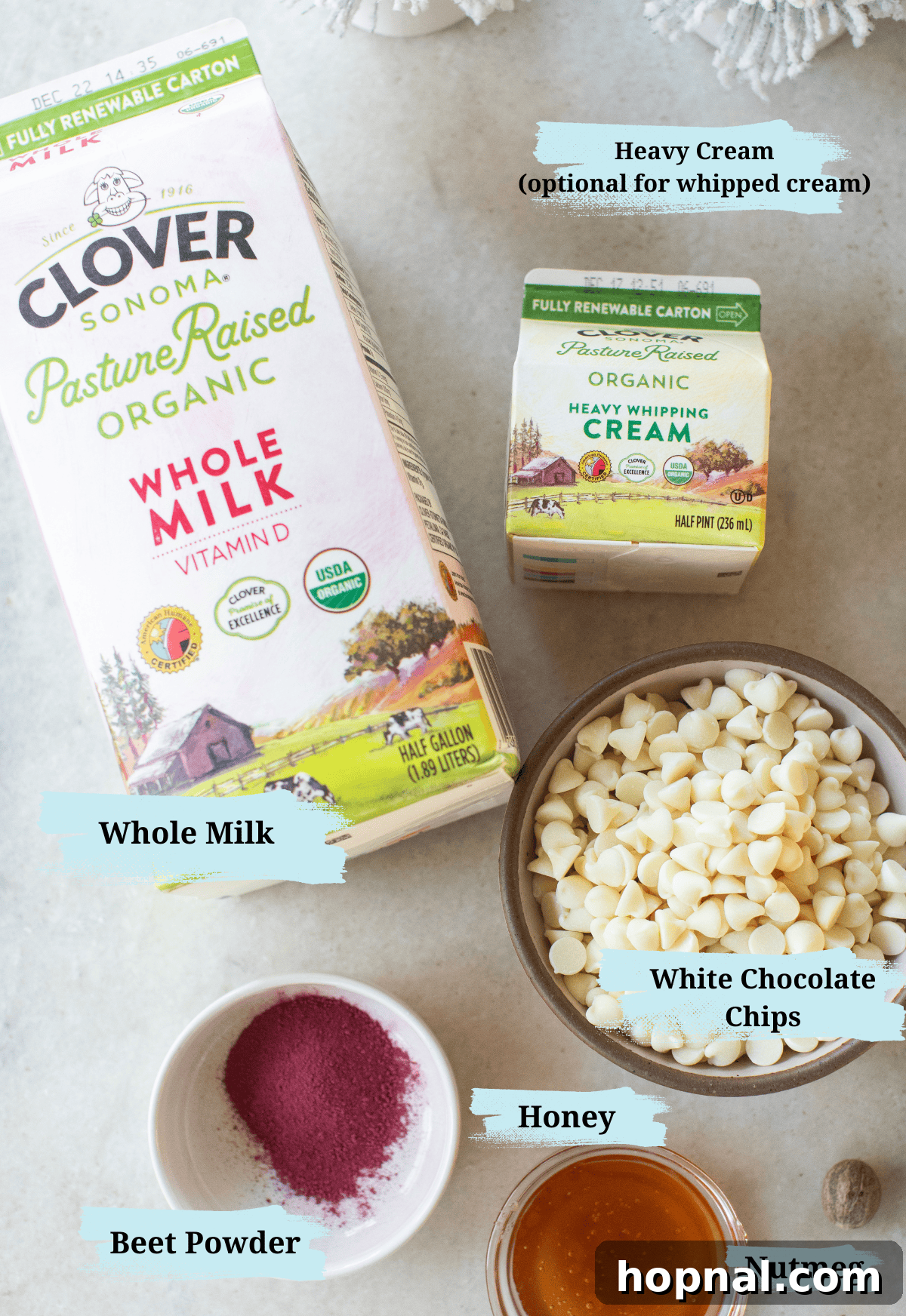 Milk, beet powder, honey, white chocolate chips, and nutmeg to make pink hot chocolate.