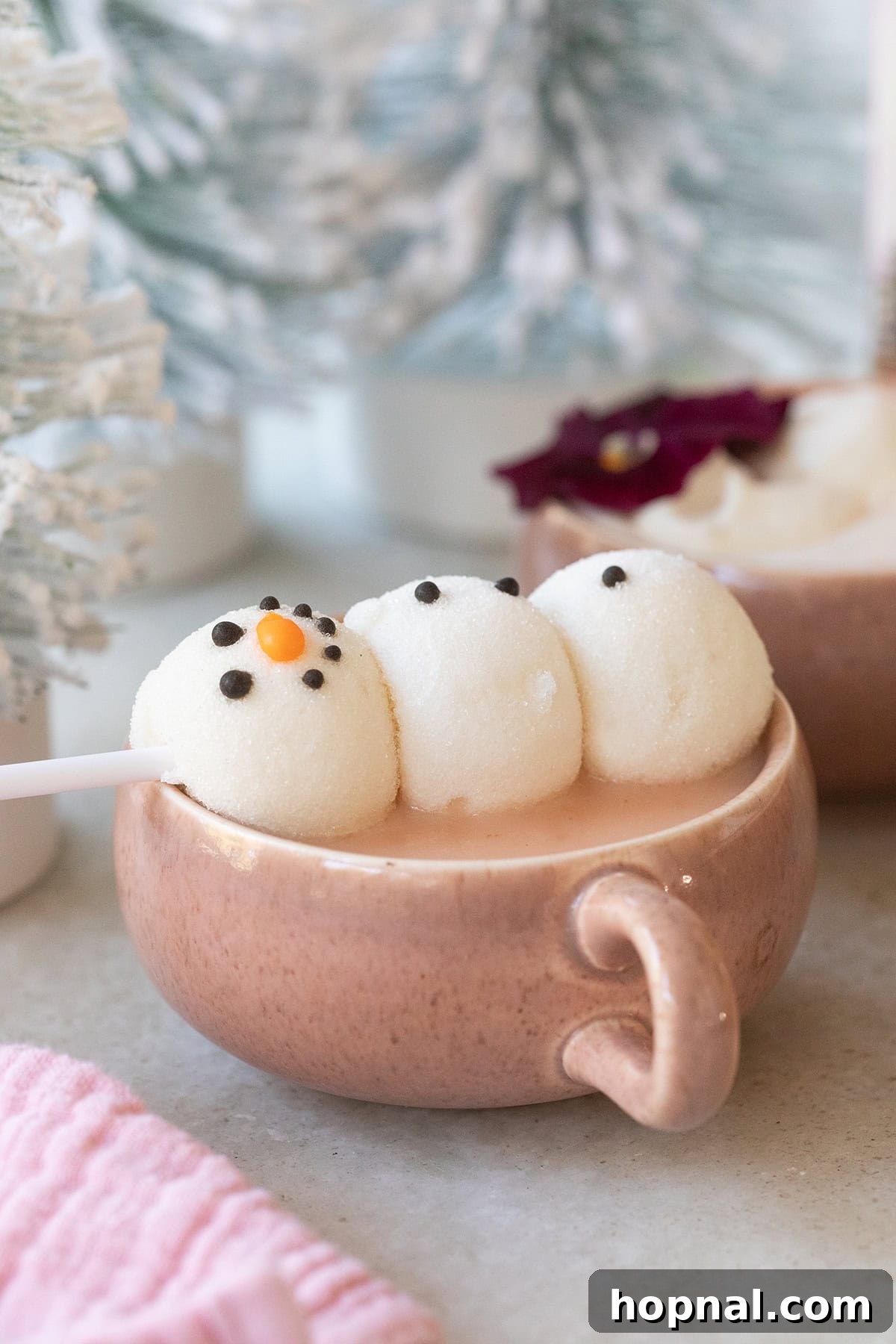 Pink hot chocolate with a snowman marshmallow. 