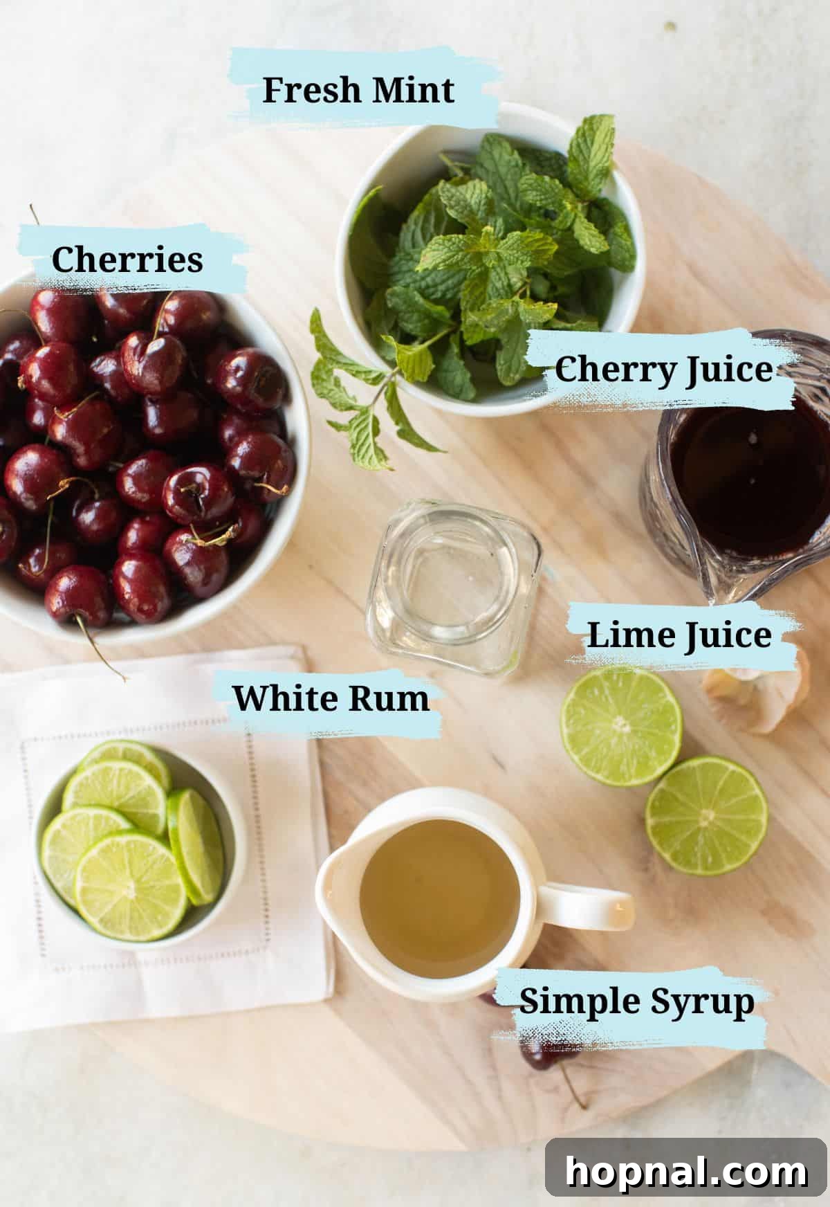 White rum, lime juice, cherry juice, simple syrup and mint leaves in bowls, ready for cocktail making.