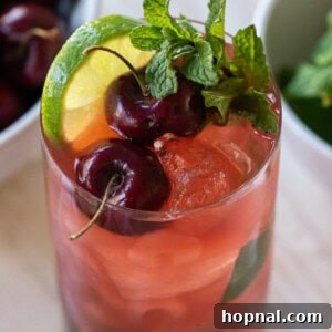 Cherry mojito recipe with fresh cherries and mint, presented invitingly.