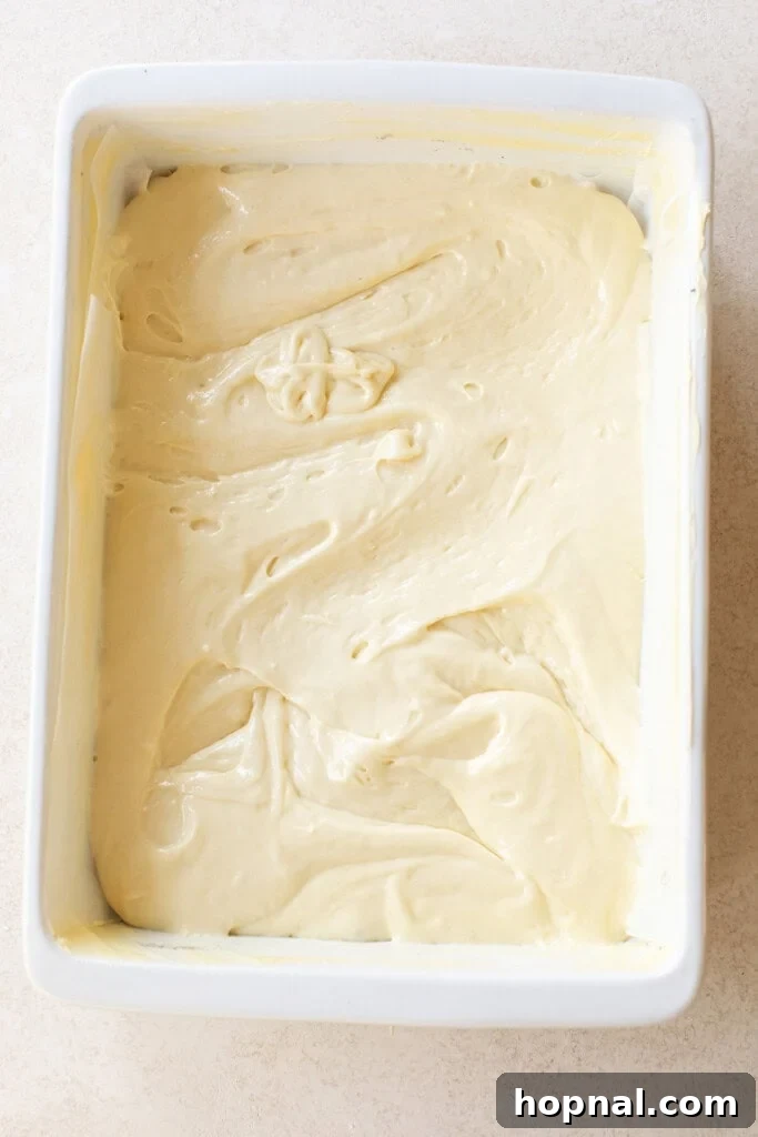 Coconut poke cake in a cake pan.