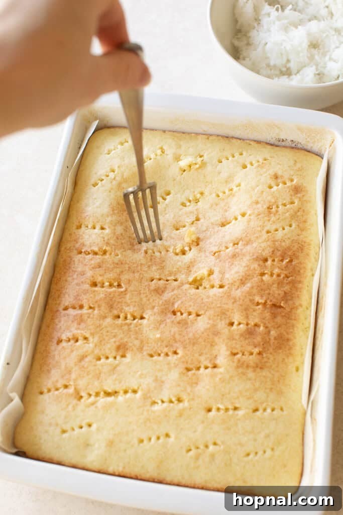 Poking holes into a golden brown cake.