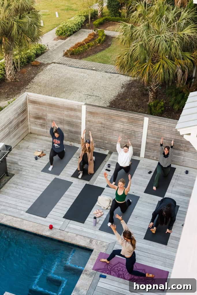 A group participating in sunrise yoga on the patio overlooking the ocean