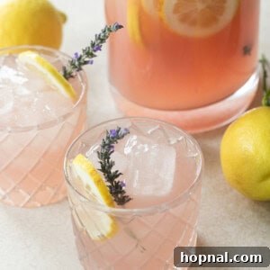 Lavender lemonade in glasses with lemons and fresh lavender.