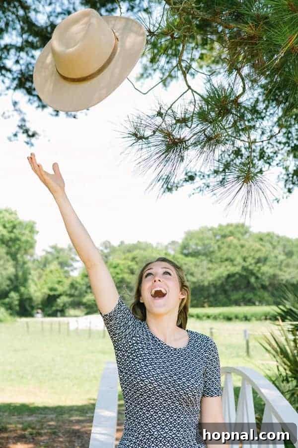 Eden Passante joyfully tossing her hat against a charming Charleston backdrop