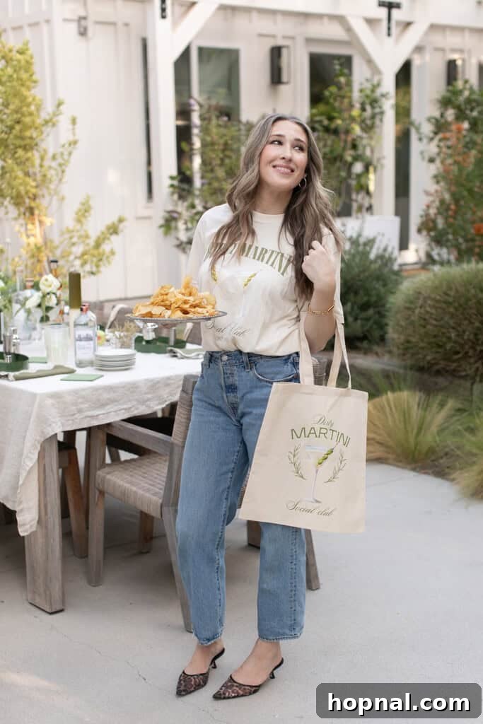 Eden Passante, the host, holding a custom martini social tote bag, showcasing a thoughtful party favor.